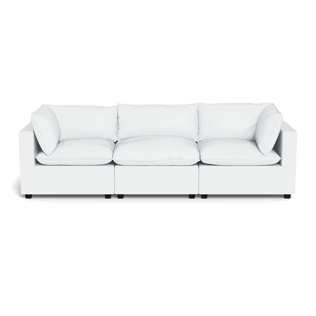 The Kova Pillow Cushion Sofa 122" is a modern white three-seat sofa with square armrests and plush cushions, shown from the front against a plain black background.