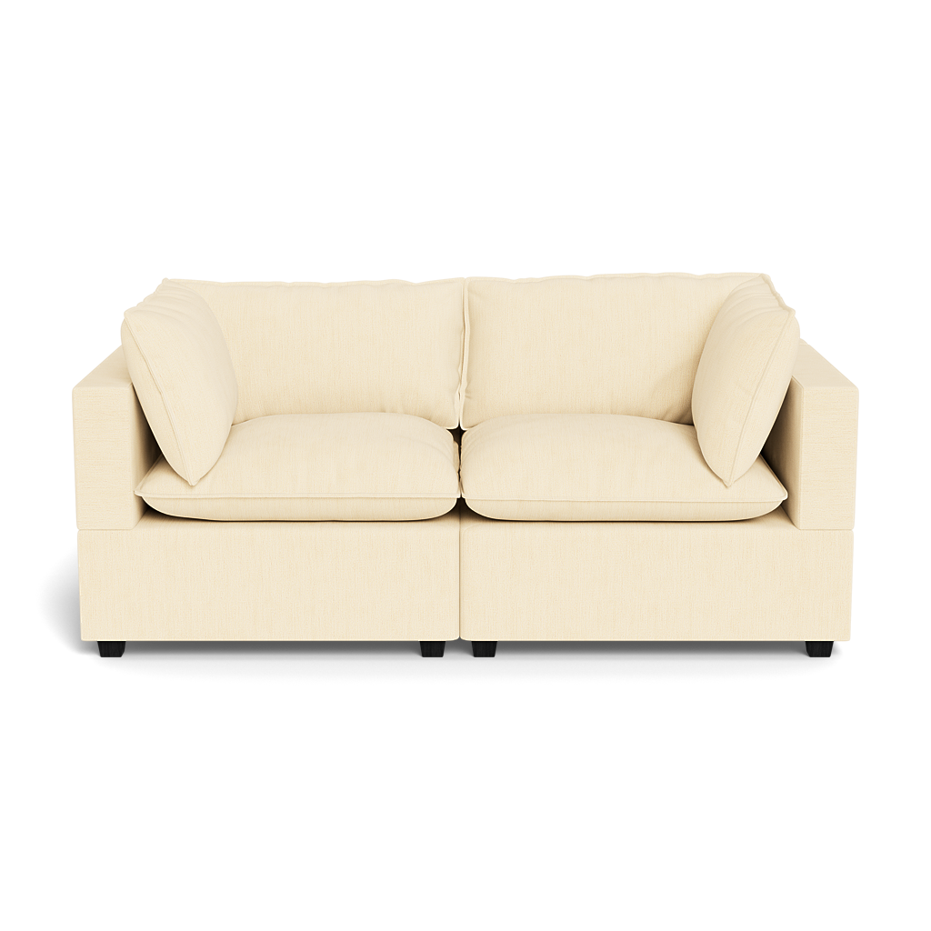 The Kova Pillow Cushion Sofa 86" is a beige, modern two-seater with plush seat and back cushions plus two matching side pillows, displayed against a black background.