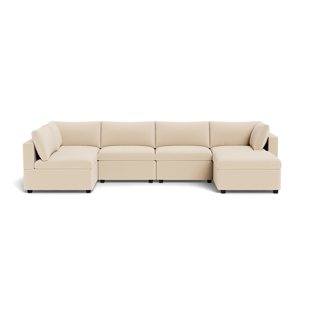 The Kova Box Cushion U-Shape is a large, modern beige sectional sofa featuring low backrests, square arms, and matching seat cushions, displayed against a plain white background.