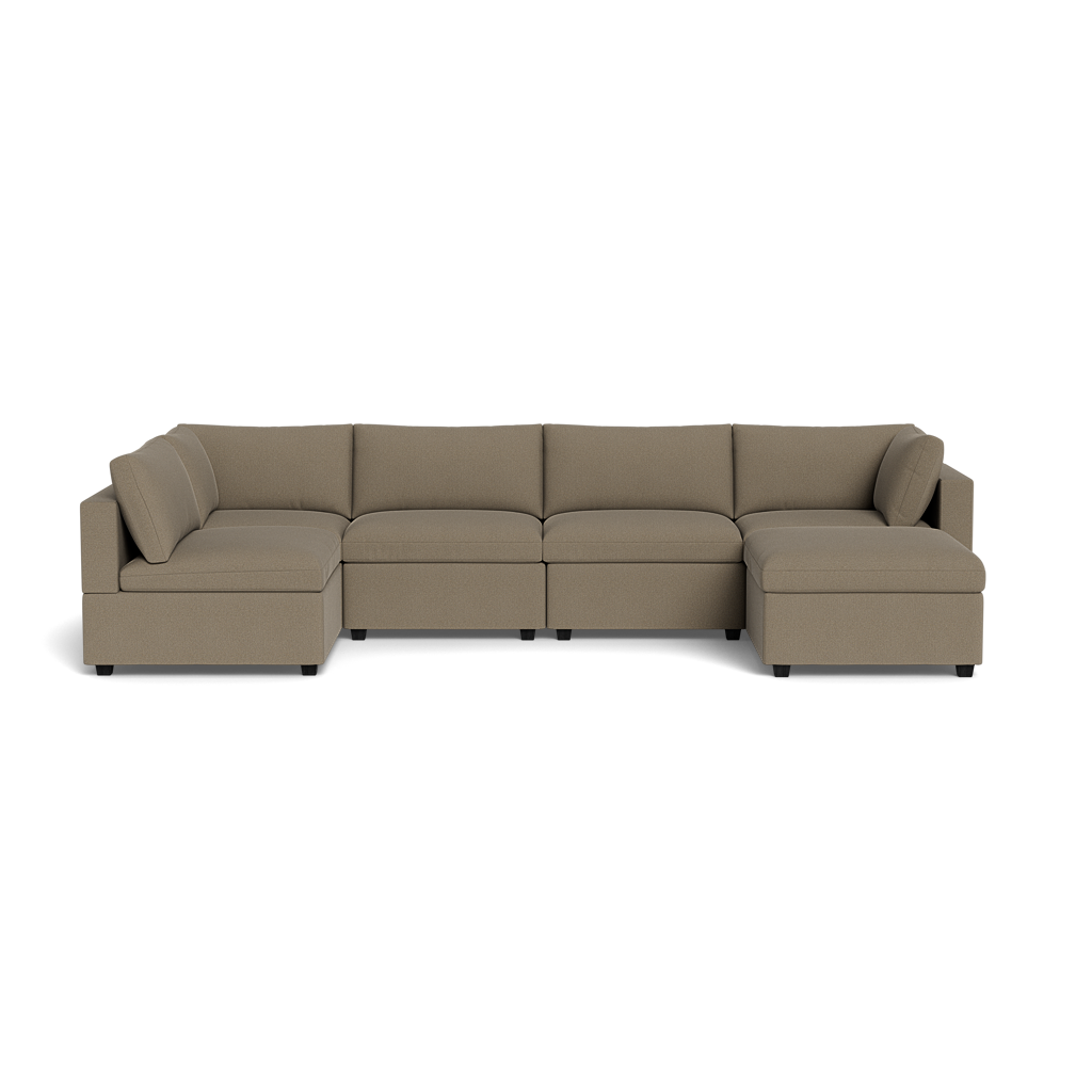 The Kova Box Cushion U-Shape is a spacious sectional sofa with a right-side chaise lounge, upholstered in light brown fabric and shown from the front against a plain black background.