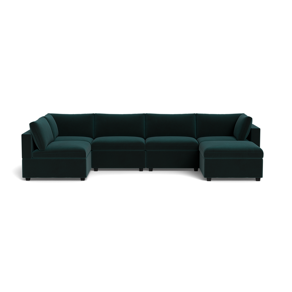 The Kova Box Cushion U-Shape, a large dark green sectional with low backrests and wide armrests, is shown against a plain black background.