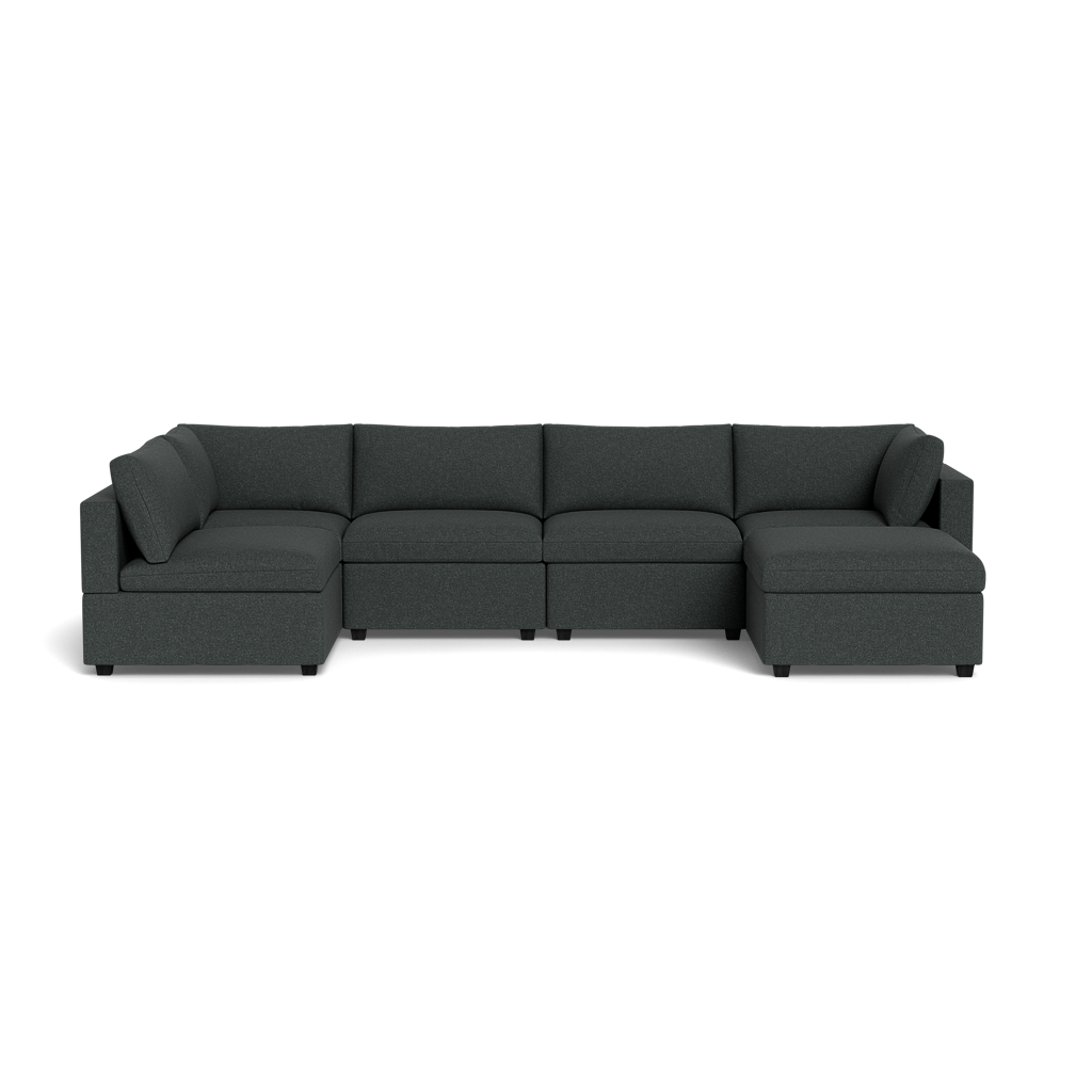 The Kova Box Cushion U-Shape is a dark gray, L-shaped sectional sofa with five seat cushions, two corner back cushions, and a right-side chaise, shown against a plain black background.