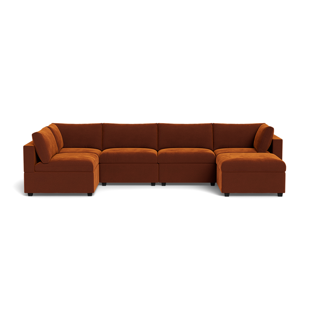 The Kova Box Cushion U-Shape is a spacious, modern sectional sofa in rust-brown, with wide armrests and plush cushions, arranged in a U-shape with chaise lounges at each end.
