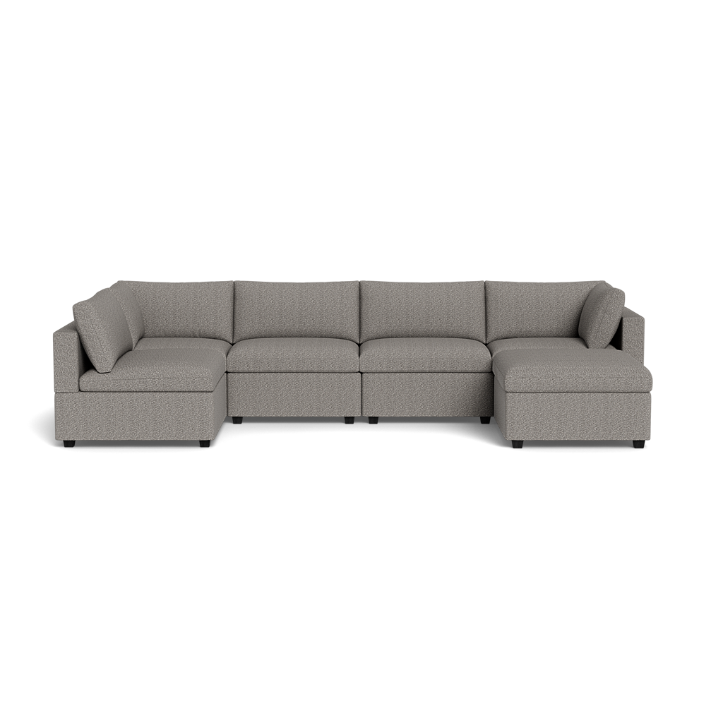 A spacious Kova Box Cushion U-Shape gray sectional with five seats and two corner armrests is set against a plain black background.