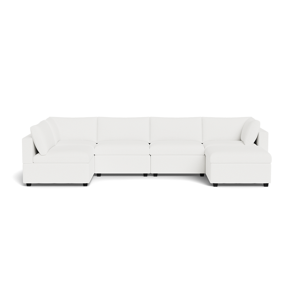 The Kova Box Cushion U-Shape is a large, modern white sectional sofa with clean lines, low backrests, and multiple connected seating sections arranged in a U-shape.