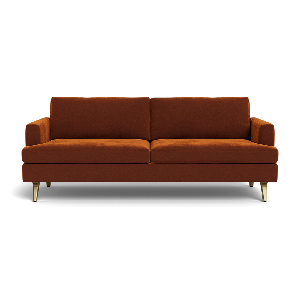 The Lido Sofa 75" is a modern, mid-century style burnt orange sofa with two seat and back cushions, low arms, and four angled metal legs.