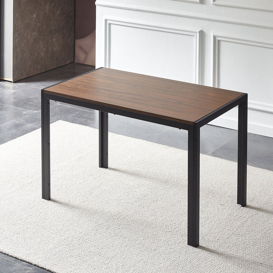 The Creative Design Veneered MDF Wood Structure Rectangular Walnut Dining Table stands on a light-colored rug in a room with gray tile floors and white paneled walls, featuring black metal legs.