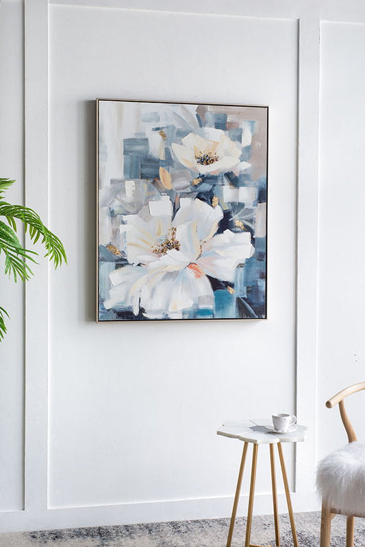 The Large Rectangle Framed Wall Art Flower Canvas Print in blue hangs above a small round table with a cup and saucer, beside a light wooden chair and green plant, adding home decor style to the space.