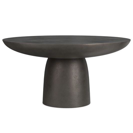 The Alexa Cast Aluminum Coffee Table features a modern design with a black finish, round wide top, and sturdy, tapered cylindrical pedestal base.