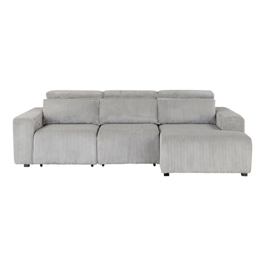The Seltos - Power Sectional - Gray is a light gray, corduroy-textured three-seat sofa with a right-side chaise lounge, wide armrests, and adjustable headrests, displayed against a plain white background.