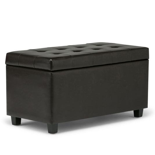 The Cosmopolitan Upholstered Storage Ottoman is rectangular, black, and tufted with short legs and a cushioned lid—ideal for storage or extra seating.