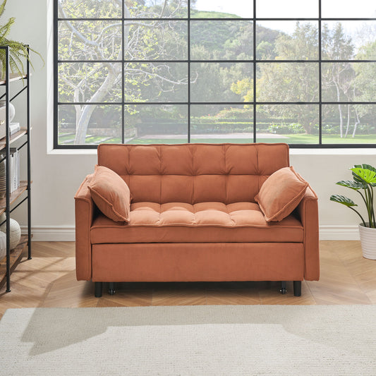 A modern living room with a large window features the Folding Sofa Bed With Adjustable Back, reclined as a loveseat with two pillows. Plants adorn each side, and a bookshelf stands on the left, overlooking hills and greenery outside.