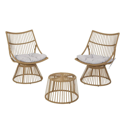 The Elaine Chair & Side Table set features two rattan chairs with white seat cushions and a matching round side table in a minimalist, open-weave design, arranged facing each other on a white background.