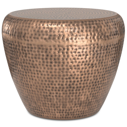 The Preston Handcrafted Metal Side Table is round and drum-shaped, featuring a hammered copper finish with a textured surface and smooth edges.