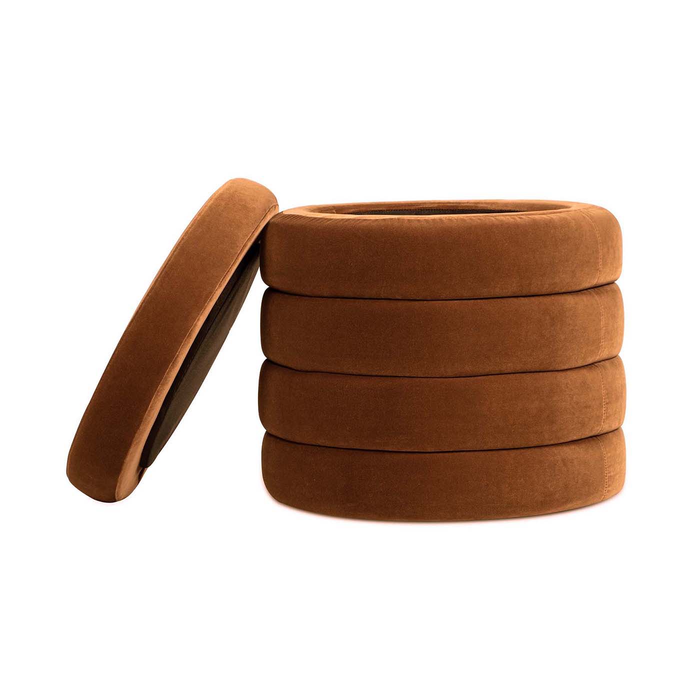 The Fuji - Oversized Round Storage Ottoman is a round, brown, stackable piece with a removable lid, featuring soft, velvety fabric and a design that resembles a stack of tires.