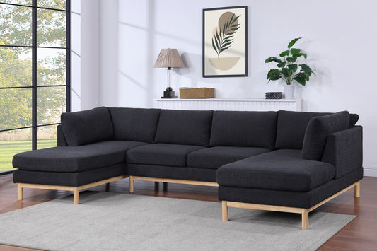 A modern living room features the Hallie Wide Sherpa Double Chaise U-Shape Sectional Sofa in dark gray on a light rug with wooden legs. Behind it are a white console, houseplant, lamp, basket, an abstract leaf print, and a large window on the left.