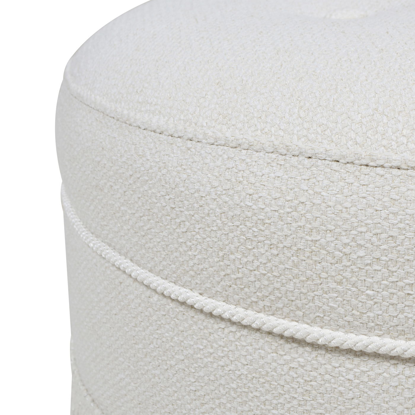 Close-up of the Yolanda - Round Upholstered Accent Ottoman in light beige, featuring a textured weave, two horizontal decorative seams around the side, soft upholstery, and neat stitching.