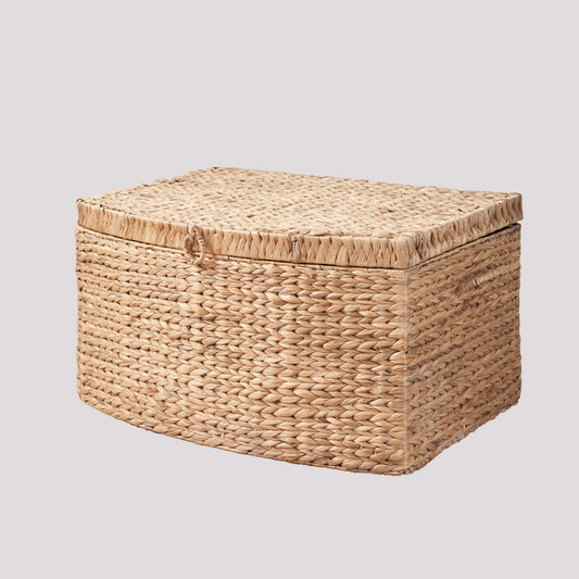 The Rectangular Curve Water Hyacinth Woven Wicker Trunk in natural/light brown, with side handles and fitted lid, is perfect for storing clothes, toys, magazines, or books; shown against a plain light background.