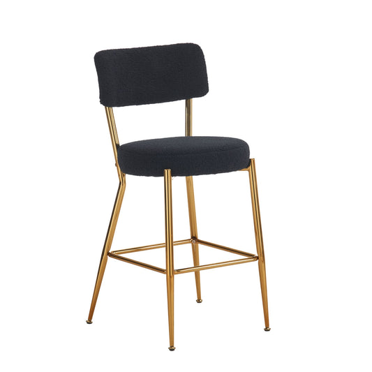 The Modern Teddy Fabric Upholstered Bar Stools feature gold metal legs, a black upholstered seat and backrest, a footrest, and a minimalist design.