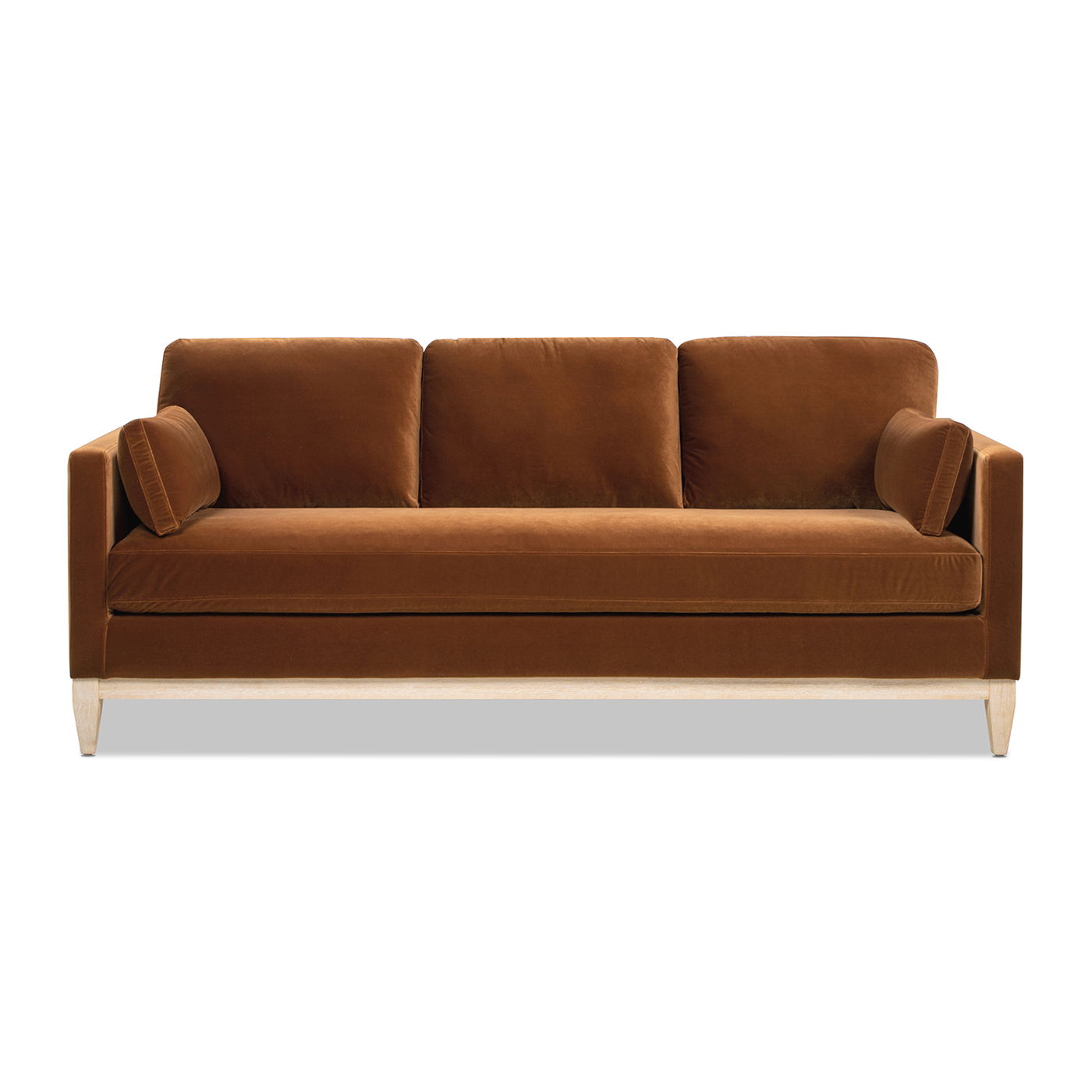 The Knox - Modern Farmhouse Sofa is a brown velvet sofa with three seat cushions, two cylindrical bolster pillows, and light wooden legs, shown from the front against a white background.