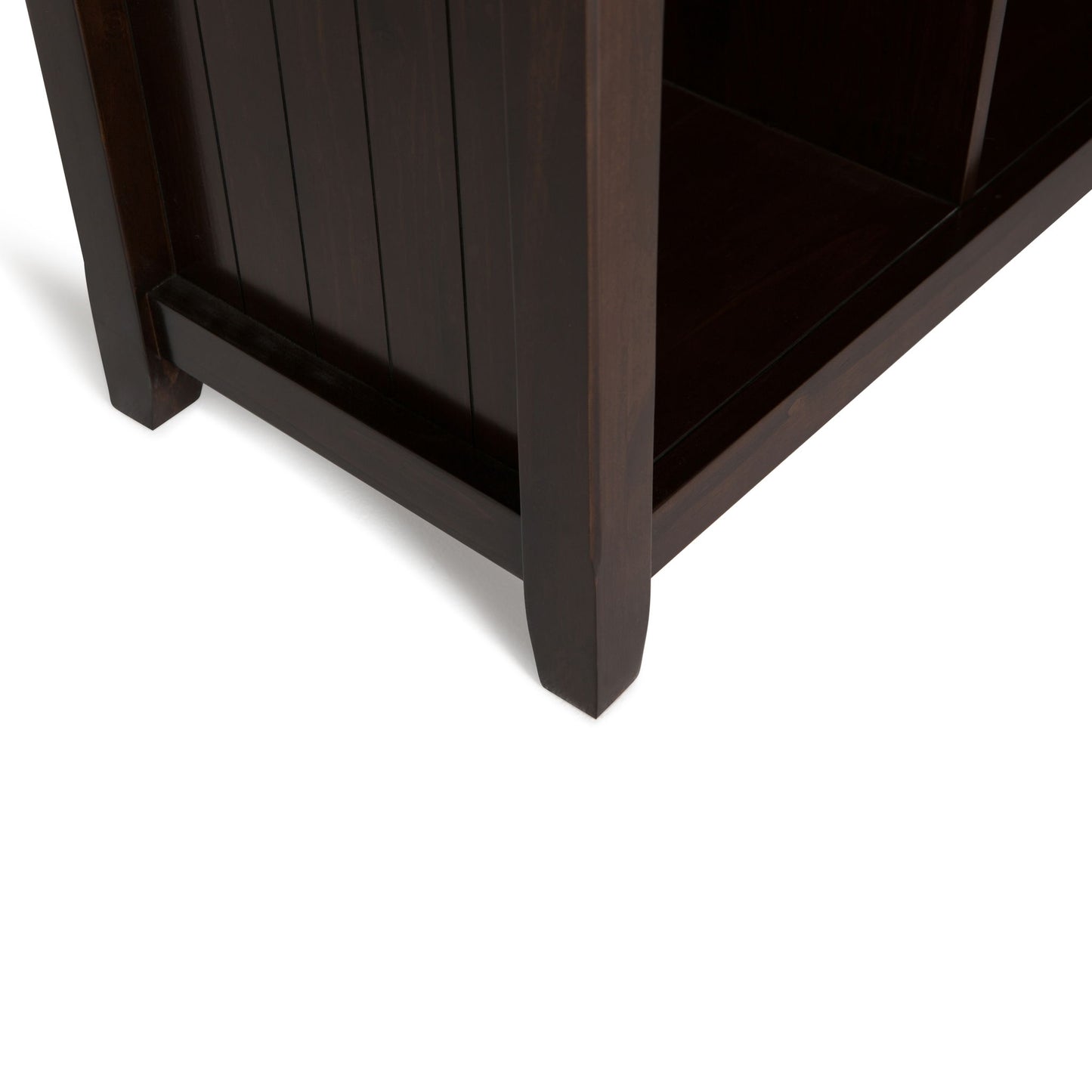 Close-up view of the bottom corner of the Acadian - Handcrafted Cube Storage, highlighting its dark wooden legs and side panels against a white background.