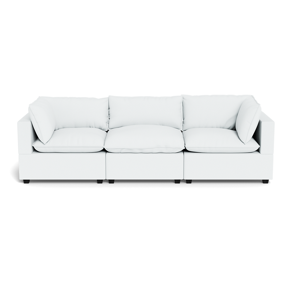 The Kova Pillow Cushion Sofa 122" is a modern white three-seat sofa with straight arms and plush cushions, shown from the front against a black background.