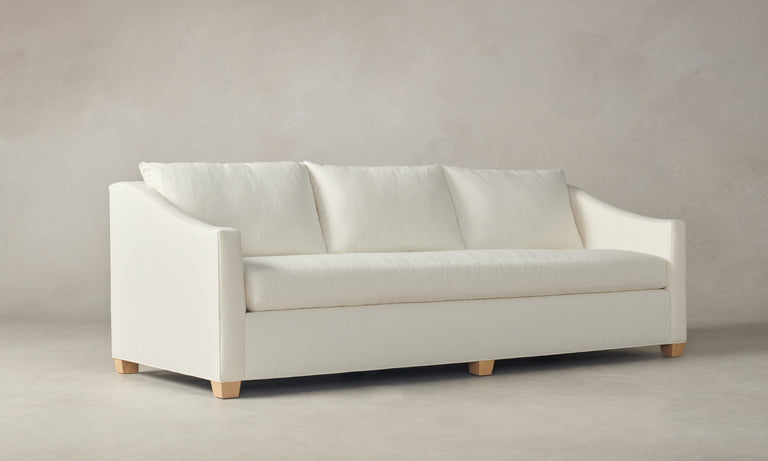 The Sullivan 60" Sofa in Performance Linen Weave, featuring three cushions and light wooden legs, set against a neutral background.