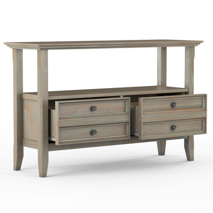The Amherst - Console Sofa Table, Handcrafted, features a natural wood finish, four tapered legs, an open shelf, and four drawers—two partially open—offering both style and functional storage.