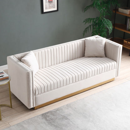 A Contemporary Vertical Channel Tufted Velvet Sofa Loveseat Upholstered 2 Pieces Set with 4 pillows, in white, is showcased in a modern living room featuring a green wall, framed art, and a potted plant.