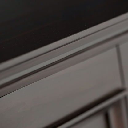 Close-up of the corner of the Amherst - Handcrafted Low Storage Cabinet, showing its dark wood finish, visible grain patterns, and smooth surfaces.