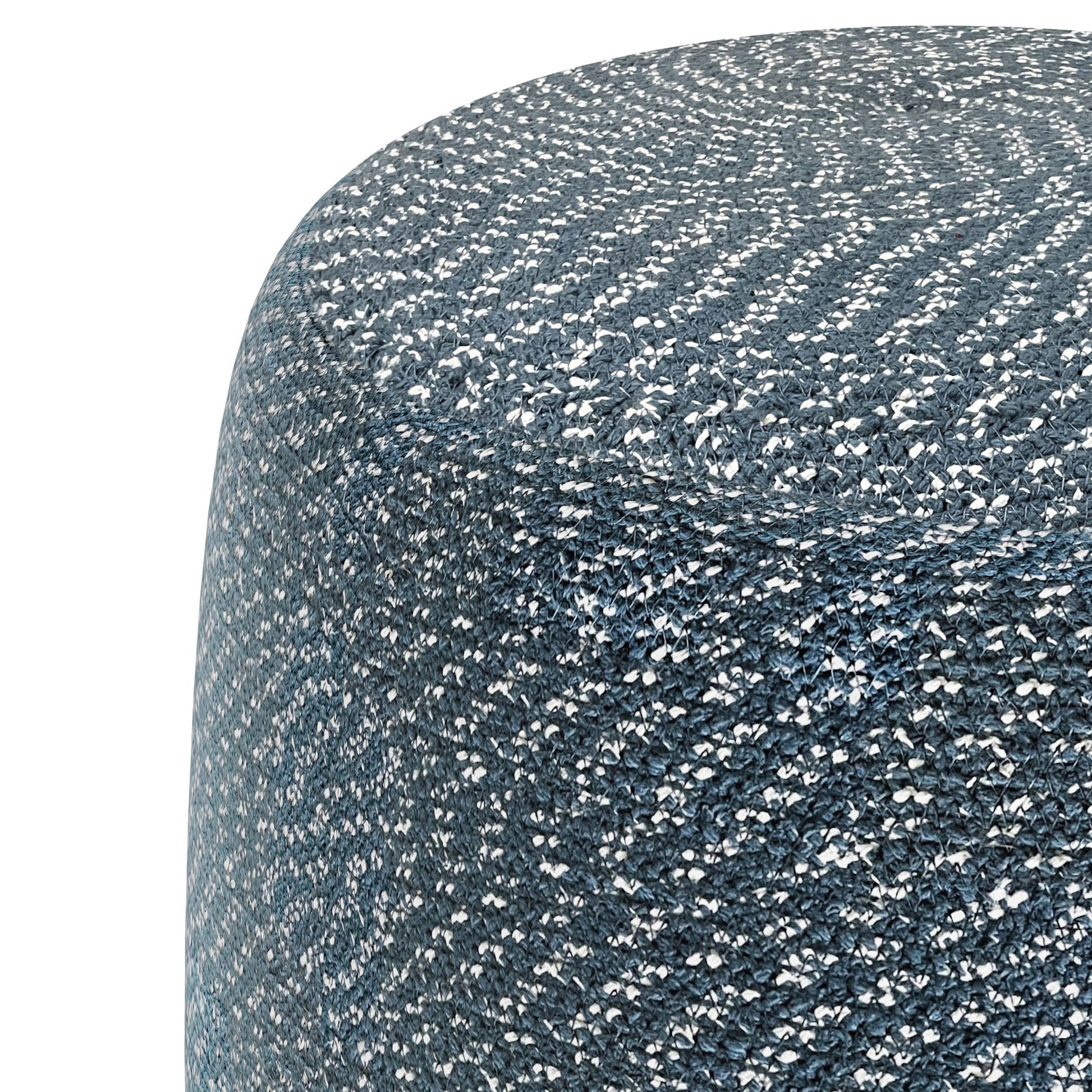 Close-up of the Bayley - Versatile Round Braided Pouf in blue and white, highlighting its woven fabric texture and curved edge against a white background.