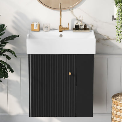 The Modern Floating Bathroom Vanity With Ceramic Basin, featuring a white rectangular sink and black ribbed cabinet, sits beneath a round mirror on a light wall with plants—ideal for small bathrooms.