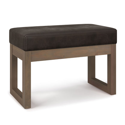 The Milltown Upholstered Ottoman Bench features a rectangular design with a dark brown cushioned seat and open square legs, displayed against a white background.