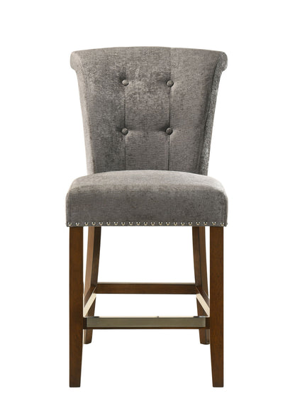 The Auggie 20.5" Fabric Counter Height Chair features gray upholstery, a tufted backrest, silver nailhead trim, and wooden legs, shown from the front on a white background.