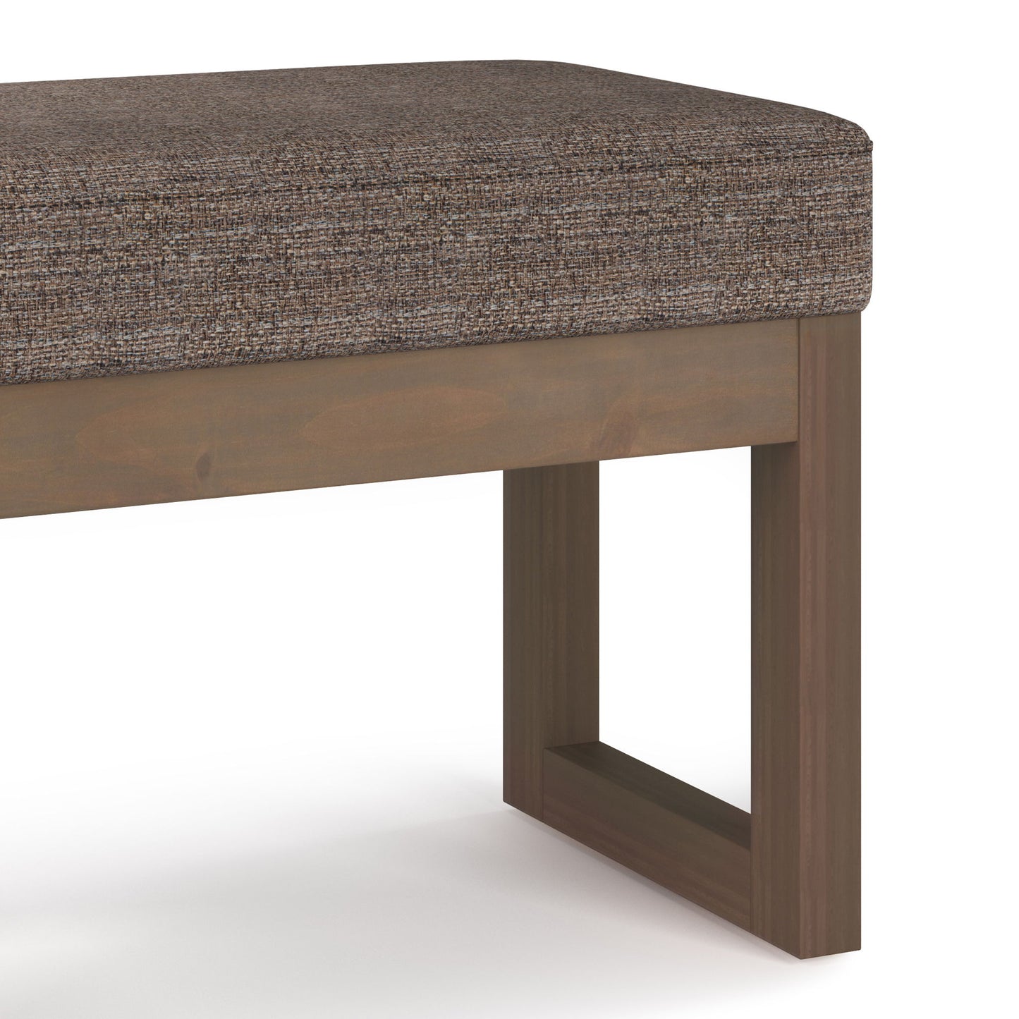 A close-up of the Milltown Upholstered Ottoman Bench shows its brown fabric cushion and simple wooden base with clean lines and rectangular legs, set against a plain white background.