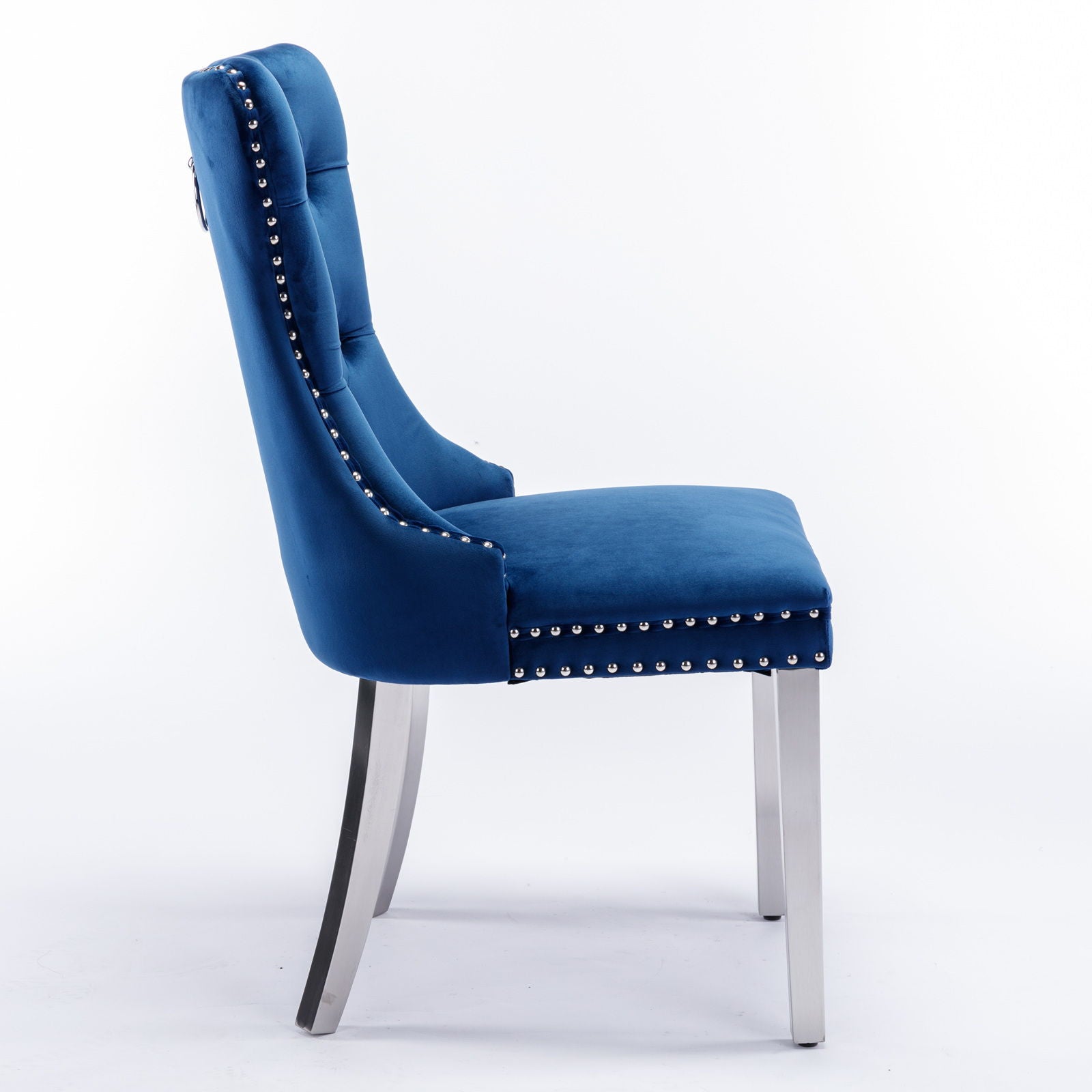 Side view of the Nikki blue velvet dining chair, a modern high-end set with button tufting, nailhead trim, and chrome stainless steel-plated legs, shown against a plain white background.