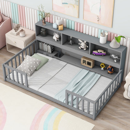 The Floor Bed With Bedside Bookcase features gray guardrails, a headboard with shelves for toys and books, and comes with pillows and a blanket in a pastel-themed room with striped wall panels and a nearby side table.