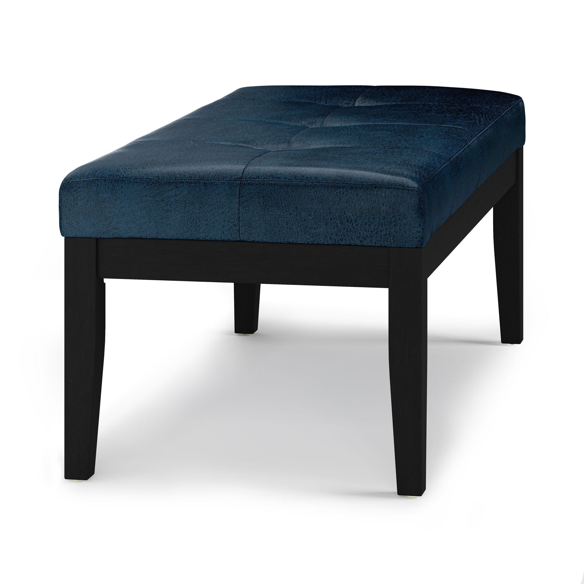 The Lacey - Upholstered Tufted Ottoman Bench features a dark blue, tufted cushion seat and black wooden legs, shown against a white background.