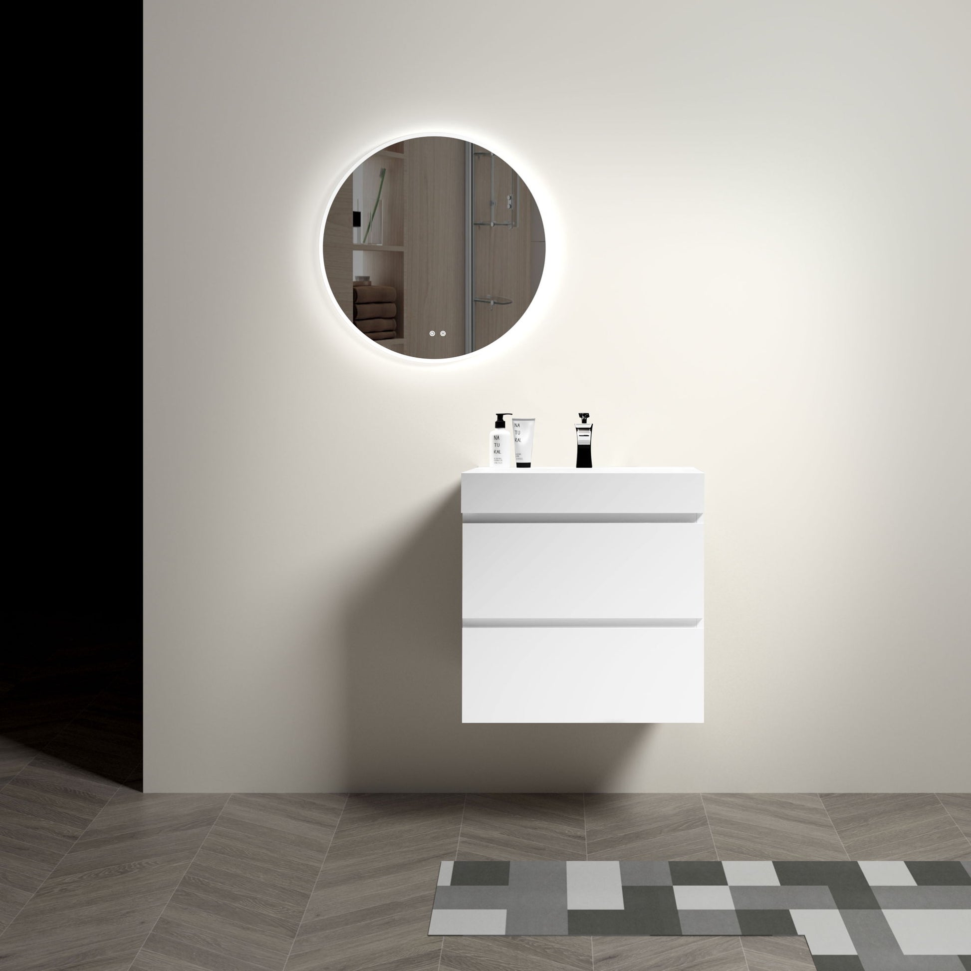 A modern bathroom features the Alice floating vanity with large storage and a one-piece sink basin, topped by a round backlit mirror. Two soap dispensers are on the vanity, while gray and beige geometric tiles cover the floor.
