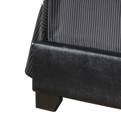 Close-up of the corner of the Elegant Platform Bed For Relaxed Spaces, featuring black upholstery and a gray and white pinstriped bedspread draped over the edge.