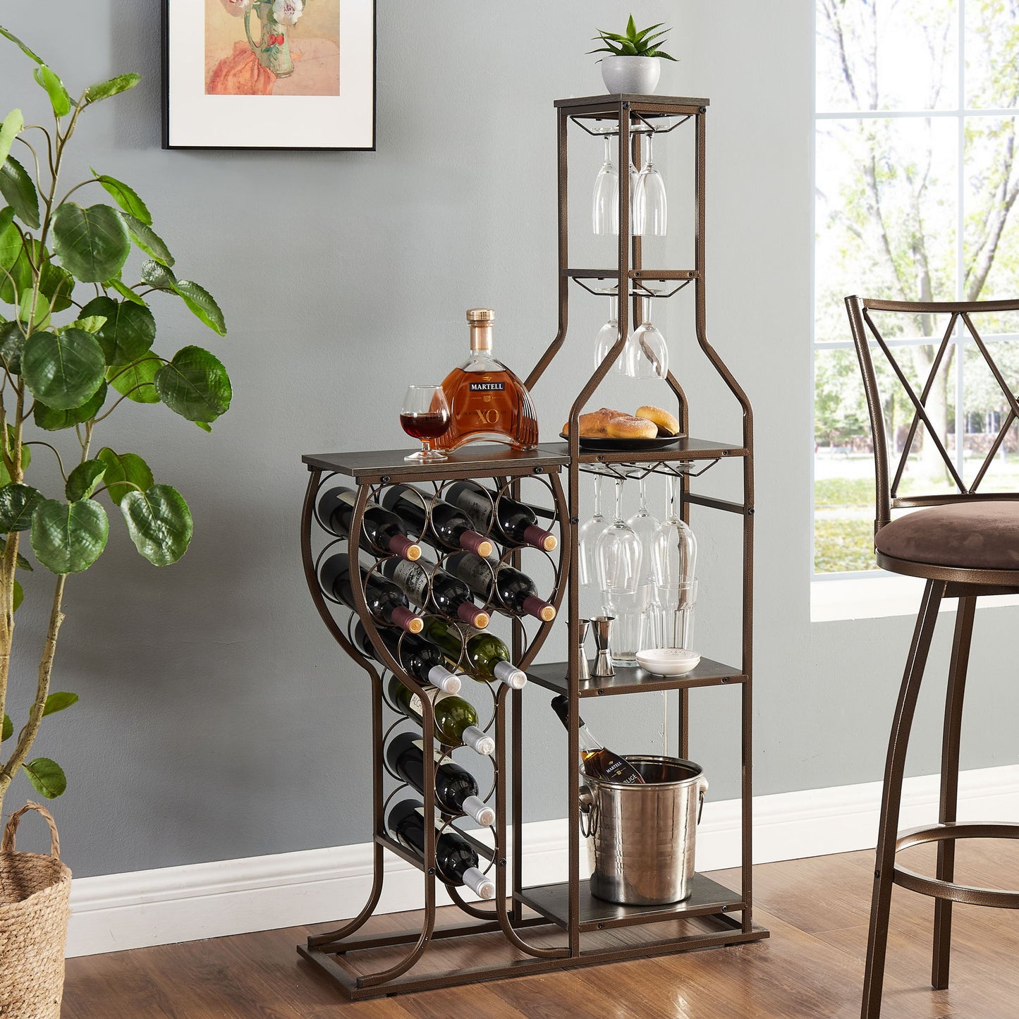 The 11 Bottle Wine Bakers Rack is a 5-tier freestanding wine rack with glass holder and storage shelves, ideal for kitchen or dining room; placed by a window, tall chair, green plant, and framed art on a light gray wall.