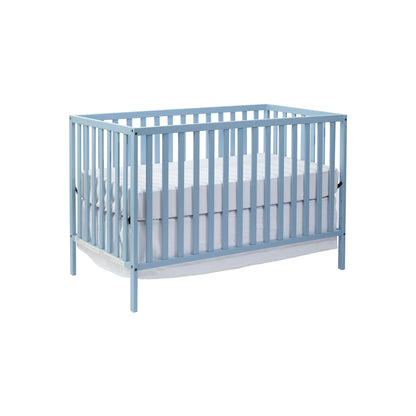 The Palmer - 3-in-1 Convertible Island Crib features a light blue wooden frame with vertical slats, a white mattress, and a white fabric storage shelf below, shown against a plain white background.
