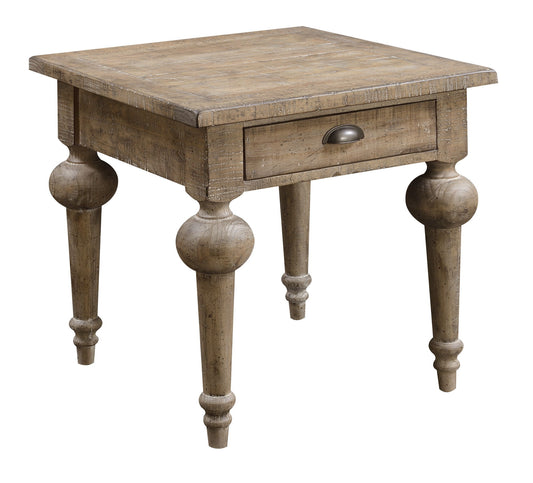 The Ludin - Table is a rustic wooden side table with a single drawer, metal pull handle, and four turned legs adorned with decorative rounded details.