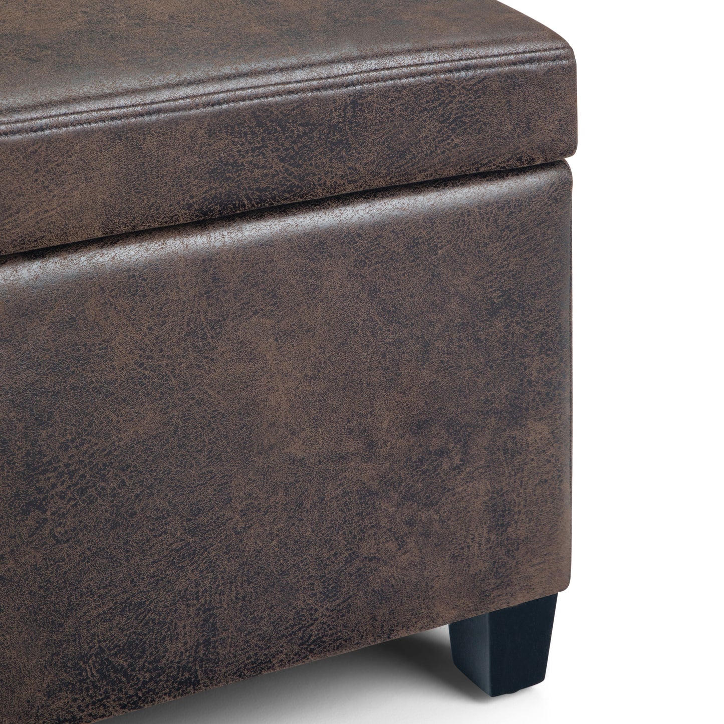 Close-up of the Avalon Storage Ottoman Bench in distressed brown faux leather, featuring visible stitching and short black wooden legs. The surface showcases a textured, weathered look.