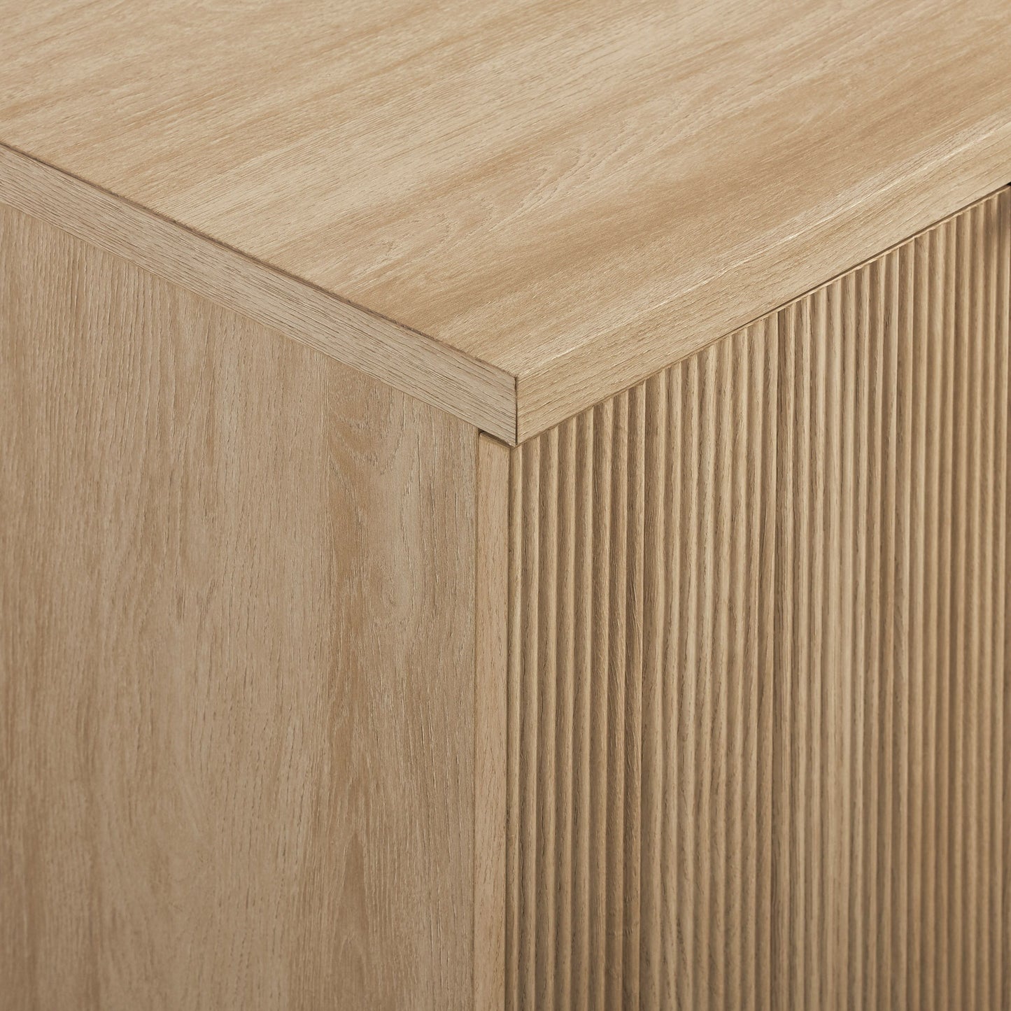Close-up of the Modern Fluted Door Minimalist Storage Sideboard, showcasing its light wood finish, smooth top surface, and vertically grooved front panels that highlight the natural wood grain texture.