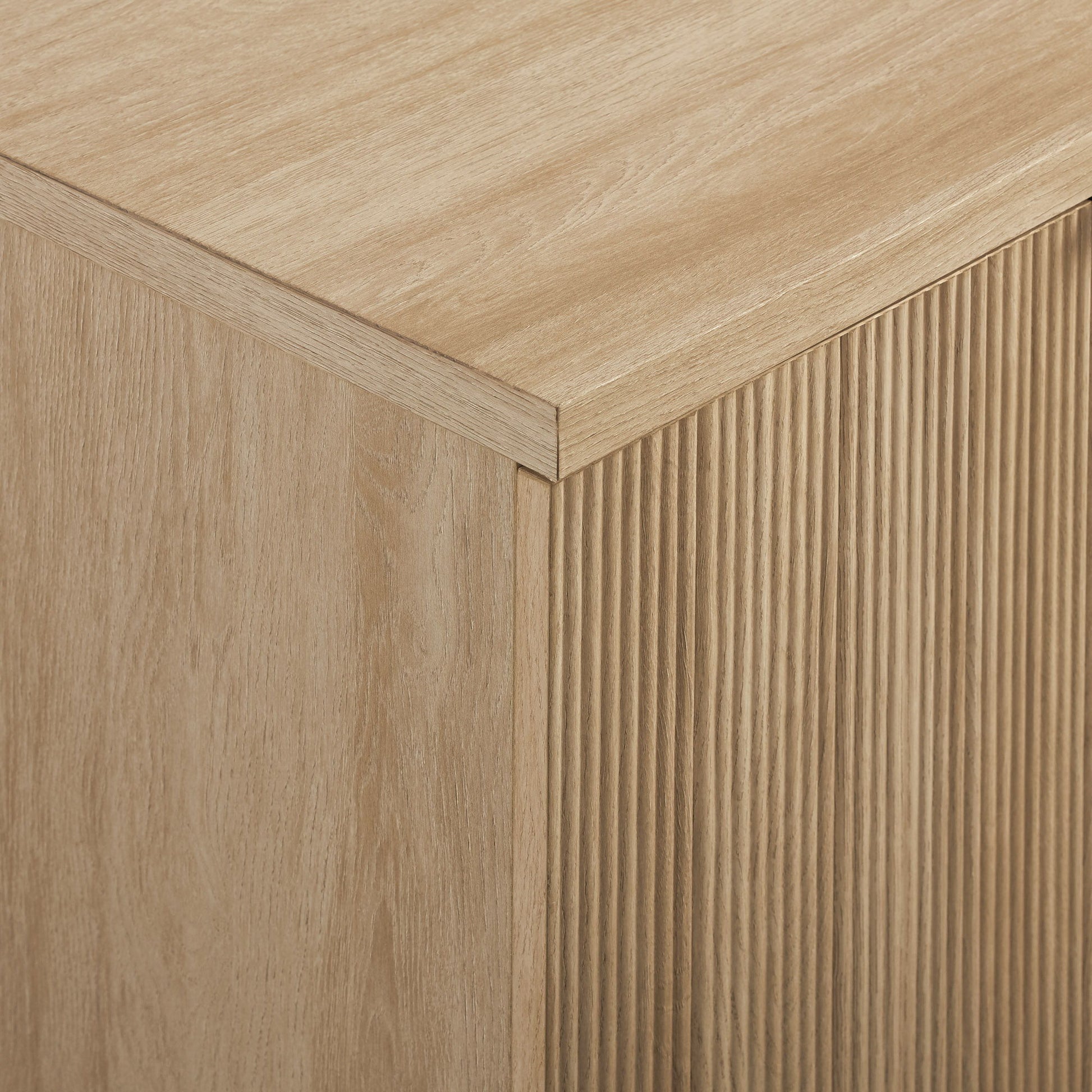 Close-up of the Modern Fluted Door Minimalist Storage Sideboard, showcasing its light wood finish, smooth top surface, and vertically grooved front panels that highlight the natural wood grain texture.
