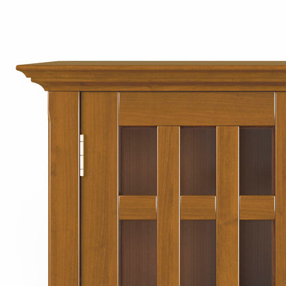 Close-up of the upper left corner of the Bedford - Storage Media Cabinet, featuring decorative crown molding and vertical rectangular glass panels framed in wood.