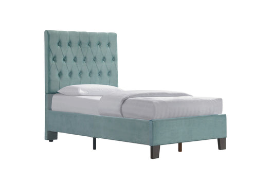 The Luma - Upholstered Bed is a single bed with a light teal tufted headboard, matching upholstered frame, dark wooden legs, and white bedding, displayed against a plain white background.
