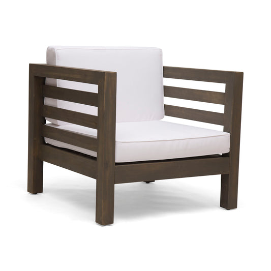 The Outdoor Acacia Wood Patio Chair With Fabric Cushion features a dark acacia wood frame, wide slatted armrests, and thick white seat and back cushions for a modern look.