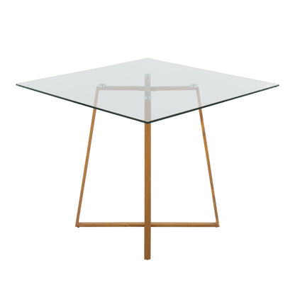 The Cosmo Contemporary Square Dining Table features a clear glass top and minimalist wooden base with four angled legs connected by metal brackets.